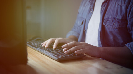 Male anonymous businessman entrepreneur working overtime alone in a dark office, work hard for his ambition of success