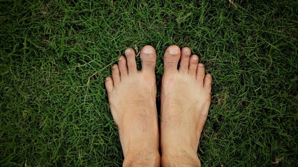 feet on grass, relaxing at lawn area in morning, meditation and fitness concept, yoga