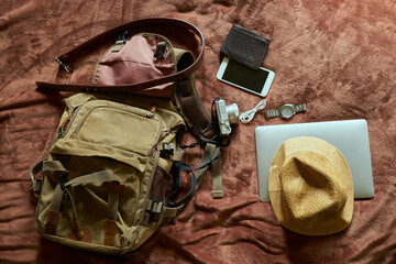 Concept travel prop with a hat and bag and laptop            
