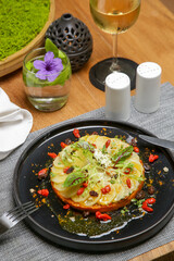 Exquisite dish. Beautifly decorated healthy organic food. Modern creative restaurant meal. Wite radish and carrot pulp decorated with salad leaves and goji berries.