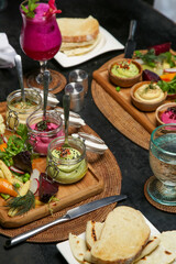 Exquisite dishes. Beautifly decorated healthy organic food served with avocado, beetrooth and classic chickpea hummus. Modern creative restaurant meal. 