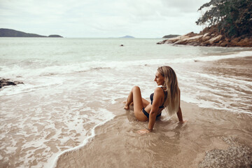    beautiful young girl enjoys the sea                        