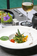 Exquisite dishes. Beautifully decorated healthy organic food served on the table. Modern creative restaurant meals.