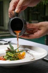 Healthy organic tomato soup. Modern creative restaurant meal. Exquisite dish, haute couture food.