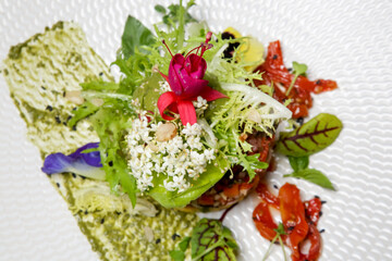 Exquisite dish. Beautifully decorated healthy organic food. Modern creative restaurant meal. 