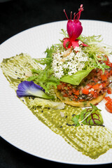 Exquisite dish. Beautifully decorated healthy organic food. Modern creative restaurant meal. 