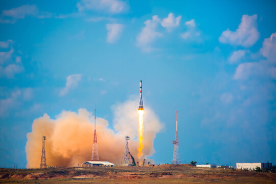 Take-off of a real launch vehicle from a spaceport. A rocket takes off into the sky against a background of clouds. Startup concept, power of science and technology. Modern technology