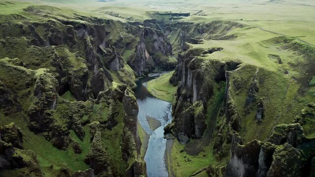 Unique rugged landscape of Fjadrargljufur canyon covered by beautiful green moss, located in southern Iceland. Aerial shot.