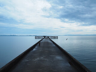 Fototapeta na wymiar The pier after morning rain in the sea.