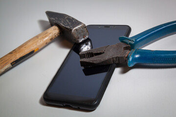 Hammer, pliers and smartphone.