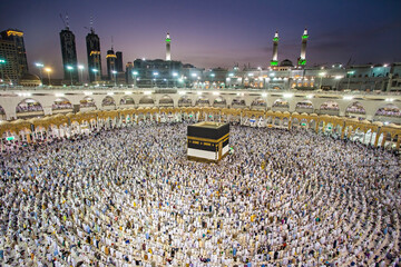 Muslim pilgrims from all around the world doing tawaf, praying around the kabah in Masjidil Haram,...