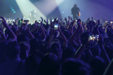 Fototapeta na wymiar blur of People shooting video or photo in music brand showing on stage or Concert Live, party concept