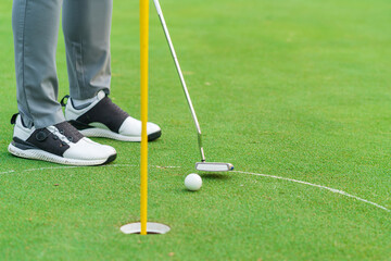 Golfer preparing for a putt Golf ball on the green during golfcourse.