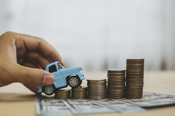 Model sky blue collar toy car park on stack coins. 