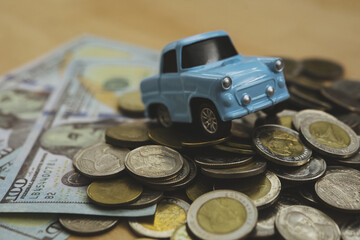 Model sky blue collar toy car park on stack coins.