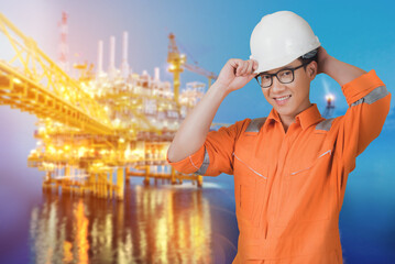 Asian confident and smart engineer man wearing coveralls suit and helmets for safety isolated on offshore oil rig platform background.