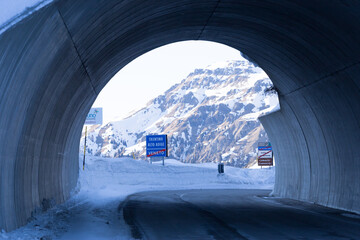 Passo Fedaia, Italy, 02/21/2020 , Gallery on Passo Fedaia, indicating the borderline between...