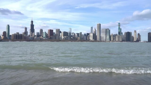 Left to right Panning shot of the Chicago Skyline and high Lake Michigan water levels along the Museum Campus