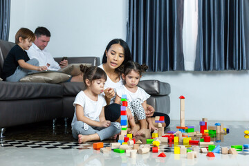 The mother is talking to the daughter who quarreled while playing the toys. Family and children...
