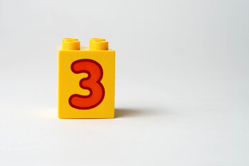the number three written on the block from the children's constructor