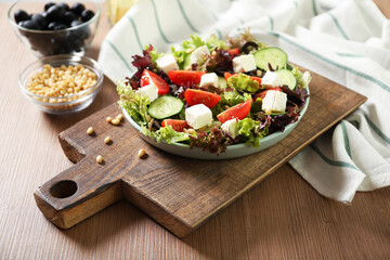 Plate with tasty greek salad on the table. Salad recipe