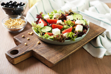 Plate with tasty greek salad on the table. Salad recipe