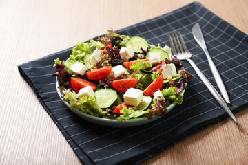 Plate with tasty greek salad on the table. Salad recipe