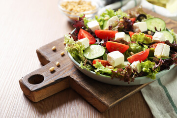 Plate with tasty greek salad on the table. Salad recipe
