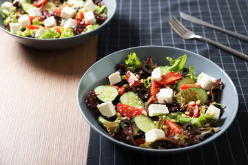 Tasty greek salad with fresh vegetables in a plate.