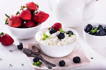healthy breakfast cottage cheese in white bowl with fresh summer  berries