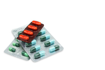 Antibiotic capsule and medicine tablet in blister packages with copy space isolated on white background.