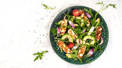 grilled Halloumi cheese with salad fresh tomatoes and avocado. Healthy food, diet lunch concept. diet menu. Top view, flat lay