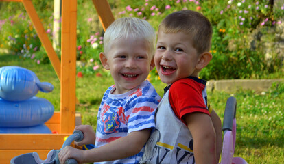 Fototapeta na wymiar Two siblings children having fun outdoors in nature together. Active summer games lifestyle