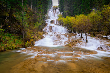 Zhaga waterfall in autumn is in Sichuan, China. View from the bottom level of the waterfall.