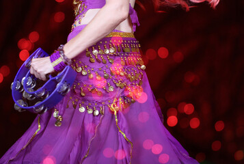 Belly Dancer Wearing Purple With Tambourine 