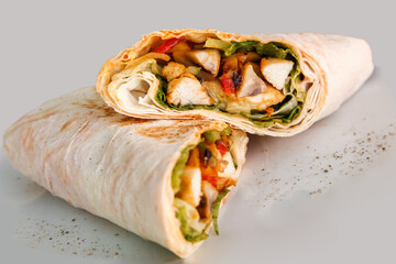 Shawarma sandwich - fresh roll of thin lavash or pita bread filled with grilled meat, mushrooms, cabbage, carrots