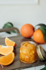 orange jam on a white background .glass jar of orange jam with fresh fruit