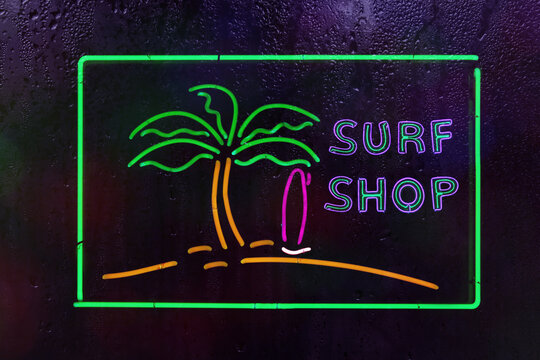 Neon Surf Shop Sign in Rainy Window