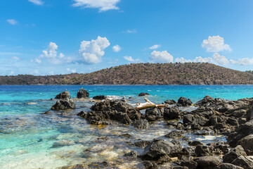 Fototapeta na wymiar Seascape with a rocky coast of the Coki Point Bech in the foreground and the Thatch Cay island in the background - St Thomas, US Virgin Islands , Caribbean