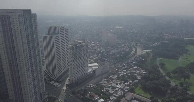 Ungraded, Descending aerial flight alongside modern building to reveal city capital's skyline. Drone, 4K. 