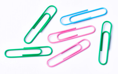 Colored paper clips close-up on a white background