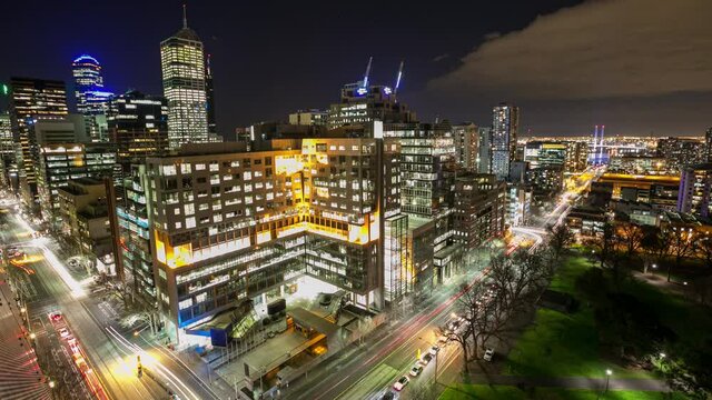 Panoramic night time lapse of city traffic while aircraft fly in, overlooking Newquay in Melbourne, Australia