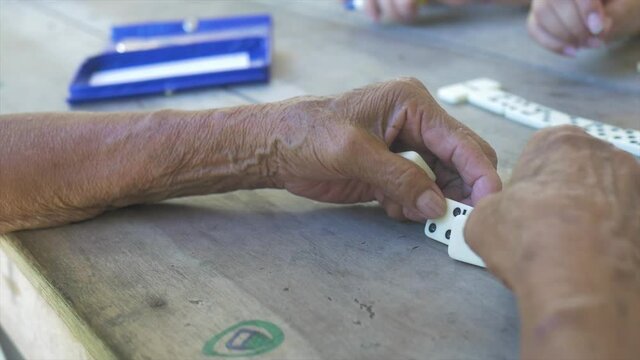 Close up of old hands playing domino game, 4k