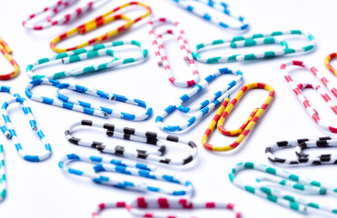 Colored paper clips close-up on a white background