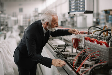 Fototapeta premium Manager checks machines at the factory. Inspector checks a factory. 