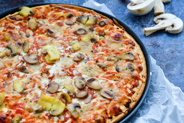  Close up of    home made  italian pizza   ham and mushroom decorated with Fresh basil, cherry tomatoes ,  mushrooms and parmesan cheese 