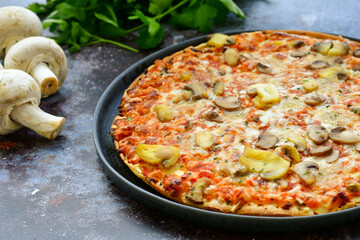  Close up of    home made  italian pizza   ham and mushroom decorated with Fresh basil, cherry tomatoes ,  mushrooms and parmesan cheese 