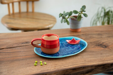 colorful handmade ceramic coffee cup on wooden table
