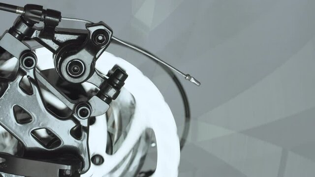 The brake system in a modern sports bike, brake disc and brake caliper with brake pads, background, copy space, closeup