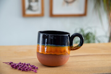 colorful handmade ceramic coffee cup on wooden table